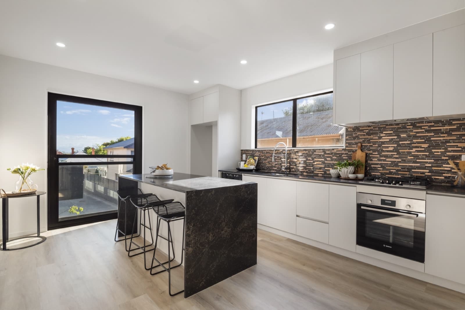 Westcott interior scheme with a copper mosaic splashback and dark stone island