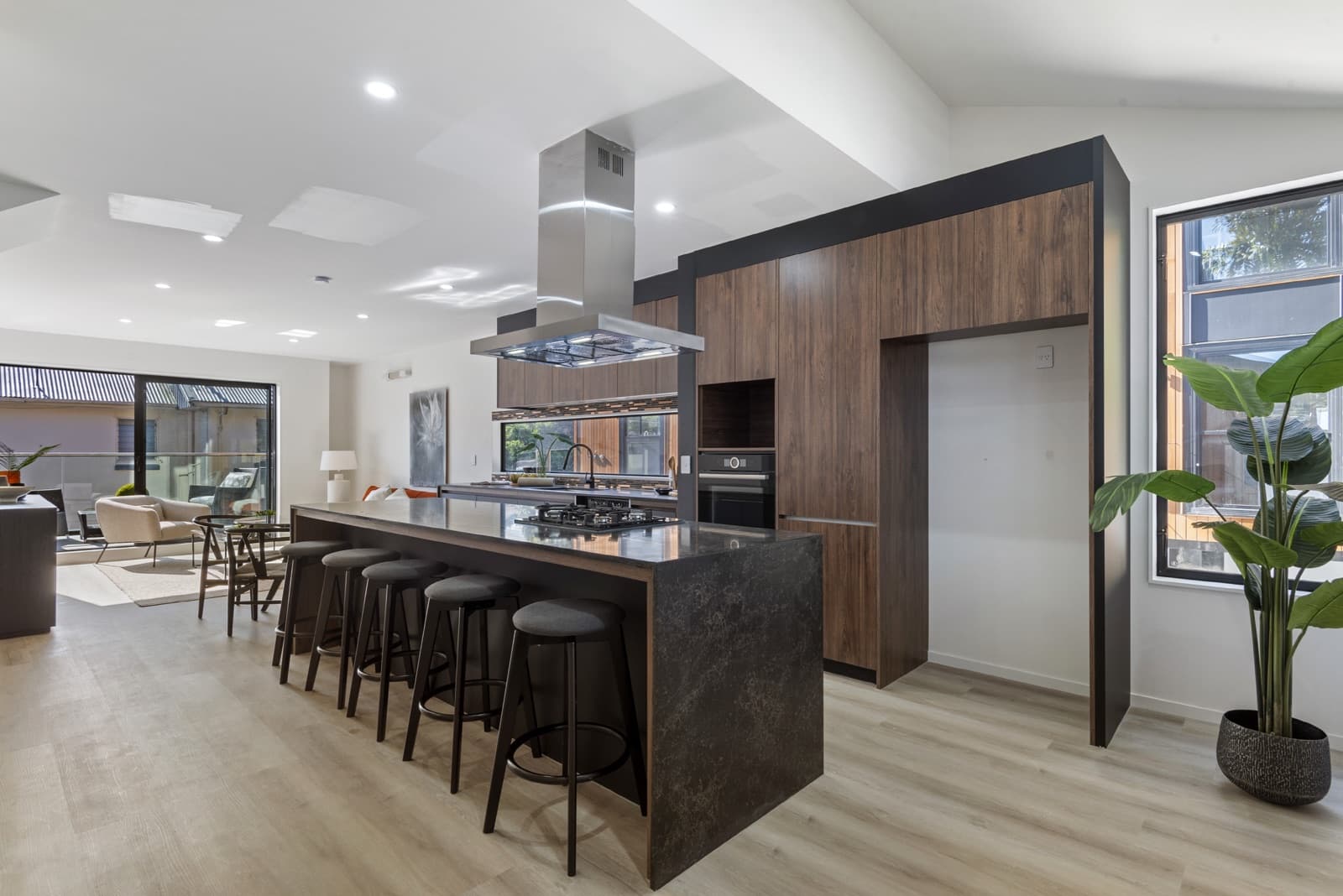 Westcott interior scheme with warm walnut cabinetry and a dark stone island