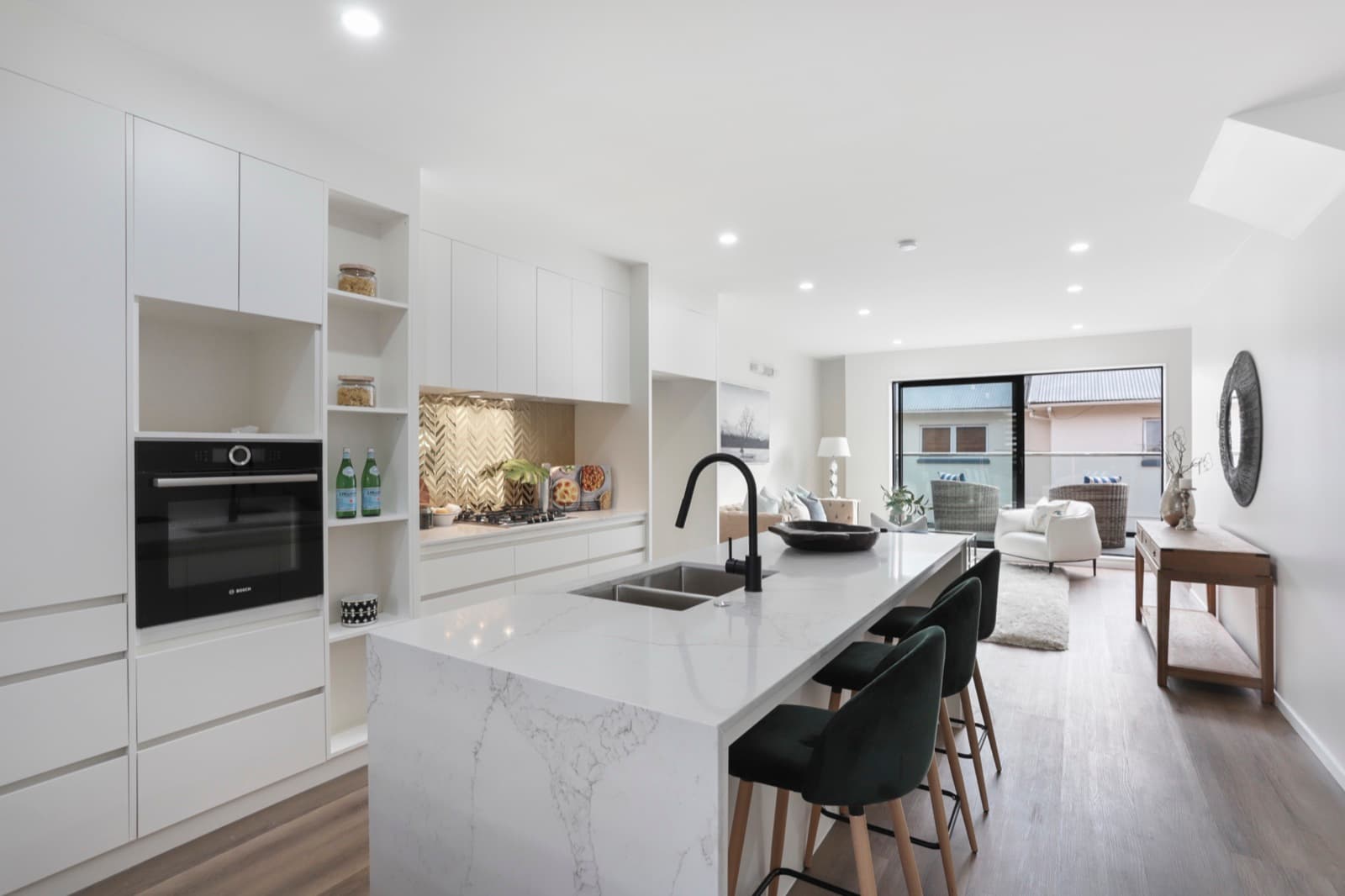 Westcott interior scheme with a brass herringbone splashback and a marble island