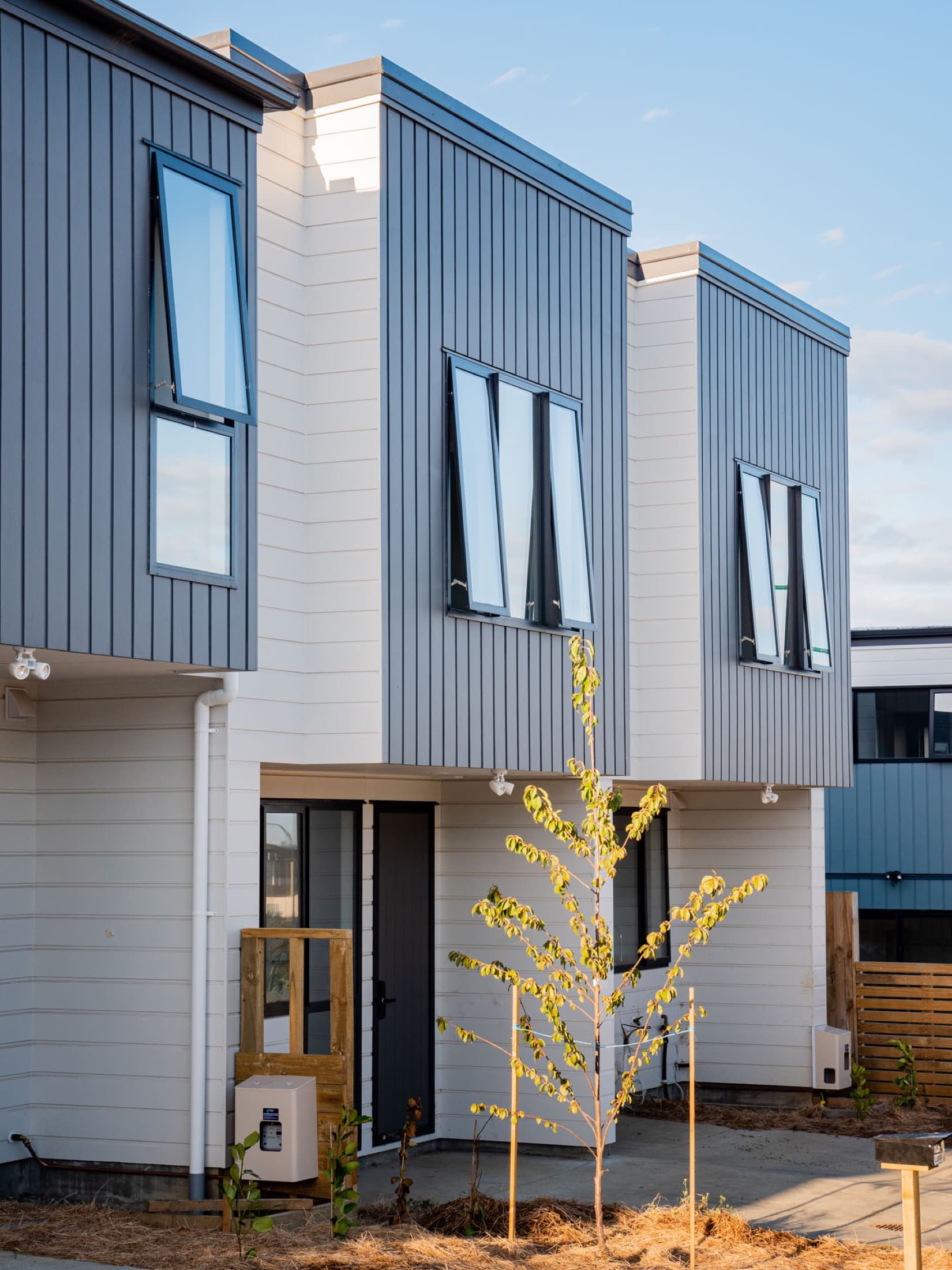 Exterior of completed Westcott townhouses at Flat Bush School Road at golden hour